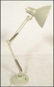 A vintage retro 20th Century 1001 Lamps anglepoise lamp raised on a circular base with conical
