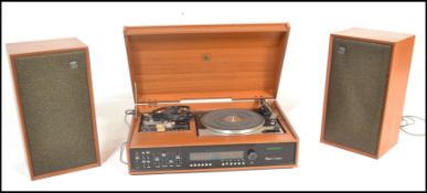 A retro mid 20th Century teak case Dynatron music center having inbuilt amplifier and tuner. The