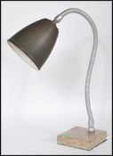 A retro 20th Century table desk lamp having dark green enamel pendant shade on a chrome gooseneck
