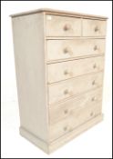A 20th Century painted pine chest of two over five drawers, the flared top over two short drawers