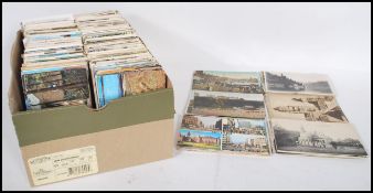 A shoebox full of various mixed small postcards dating from the early 20th Century (mostly later) to