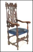 A 19th Century Victorian Carolean style carved oak arm chair, the cresting rail, with later