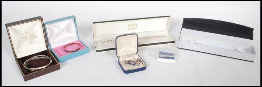 A small group of silver jewellery to include small dolphin pendant, small child's bangle, two