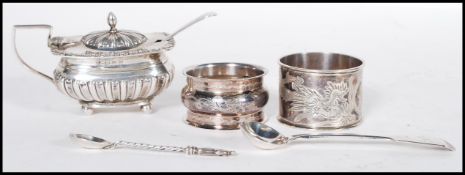 A selection of silver items, most having English hallmarks to include a mustard pot condiment having