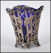 A continental silver spill vase having pierced floral decoration raised on scrolled feet complete