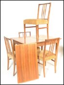 A mid 20th Century Gordon Russell of Broadway, extendable walnut draw leaf dining table and four