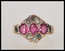 A 19th Century Victorian 15ct gold ring set with three oval cut pink stones flanked by green