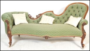 A 19th Century Victorian walnut show frame scroll back sofa, button upholstered in green dralon