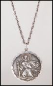 A silver English hallmarked medallion style pendant having a raised St Christopher design with an