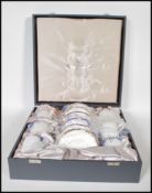 A cased Wedgwood bone China coffee can service for six in the Cavendish pattern. Gilt and cobalt