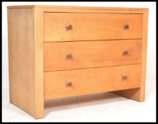 A Century Gordon Russell Cotswold School oak chest of drawers, three straight drawers with turned