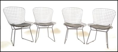 A set of four contemporary side chairs / dining chairs in the manner of Harry Bertoia 420C chairs.