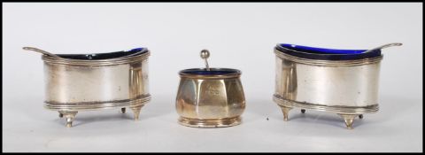 Two silver hallmarked table salts of ovular form having blue glass liners raised on cab feet (