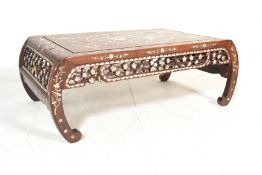 A 20th Century Chinese lacquered low opium table / coffee table raised on scroll bowed legs with