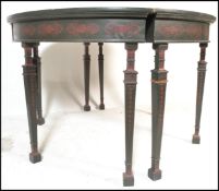 A pair of 20th Century ebonised wood demi lune D end tables having stencilled ochre decoration