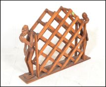 A vintage 20th Century multi section hardwood wine rack mounted on plinth base flanked by a  pair of