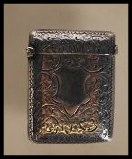 A 19th Century Victorian silver hallmarked vesta case having engraved foliate decoration with a