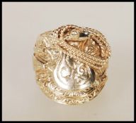A 9ct gold English hallmarked saddle ring in the form of a western saddle with stirrups and a coiled