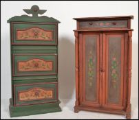 Two 20th Century Swiss style painted cabinet cupboards, the first a series of three panel drawers