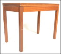 A 1960's retro 20th Century teak fold over card table, with green baize interior, raised on straight