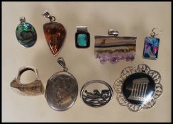 A  selection of silver jewellery to include a stamped 925 silver antiquity brooch, an oval locket