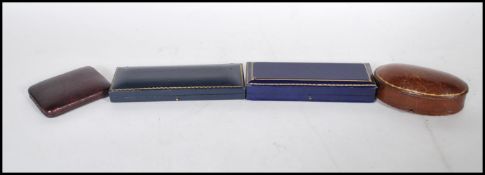 A group of four vintage early 20th Century watch boxes to include a brown leather domed box with a