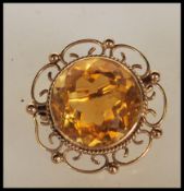 A Victorian hallmarked 9ct yellow gold brooch set with a large faceted cut citrine to the open