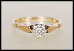 A hallmarked 9ct gold solitaire ring illusion set with a round cut white stone. Hallmarked London.