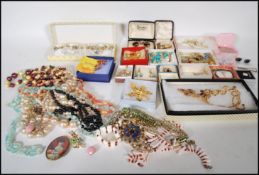 A collection of vintage 20th Century costume jewellery to include beaded necklaces, brooches, a