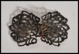 A silver hallmarked nurses belt having pierced scrolled foliate decoration constructed from two