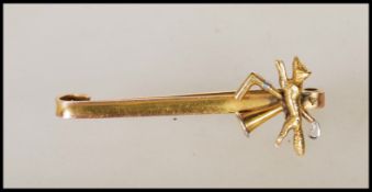 A stamped 9ct gold J Aitkin & Son hunting interest bar brooch having an applied finial with a fox