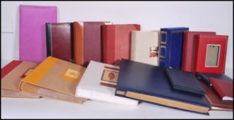 A collection of sixteen postcard / photo albums be