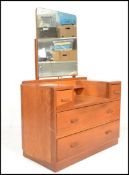 A mid 20th Century oak dressing chest in the manner of Ernst Gomme for G-Plan, central mirror