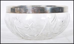 An early 20th Century cut glass centerpiece bowl having an English hallmarked collar. Hallmarked