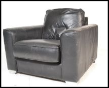 A retro 20th Century black leather Danish style easy chair/ lounge chair /  armchair, the chair of