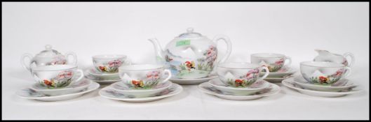 A 20th century Japanese eggshell porcelain tea  service with geisha girl lithophane panels and