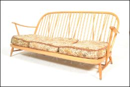 Ercol - A vintage mid 20th Century Windsor pattern three seater sofa / settee in beech and elm