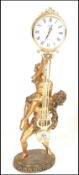 A contemporary Juliana figural pendulum quartz clock, the movement held aloft by a classical style