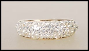 A stamped 375 9ct gold ladies cluster ring set with four rows of white accent stones to the head.