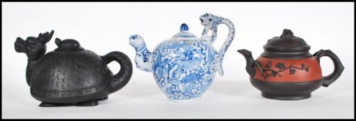 A group of three Chinese teapots dating from the e