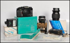 A vintage Olympus OM 40 program camera in its original box with a Olympus Zuiko Auto-S 50mm F1.8