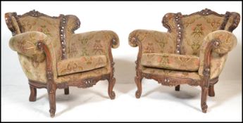 A pair of 20th Century contemporary rococo style  walnut lounge armchairs. Carved pierce show