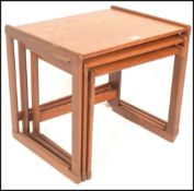 A 1970's G-Plan vintage retro teak wood nest of tables having shaped legs united by stretchers