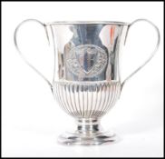 A good early 20th Century Sheffield plated twin handled trophy,the trophy raised on a stepped
