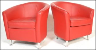 A matching pair of retro 20th Century red leather tub chairs raised on chrome supports. Measures
