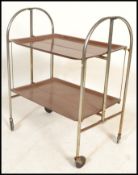 A retro mid century Gerlinol Brenshey Dinett retro chrome folding tea trolley being raised on