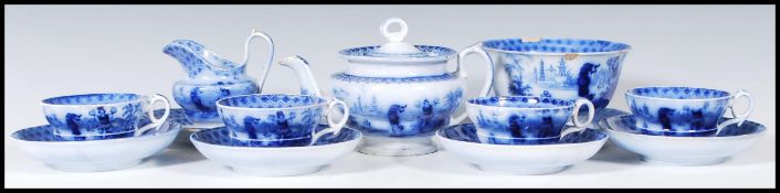 An early 19th Century flow blue / blue and white miniature child's tea service depicting Chinese
