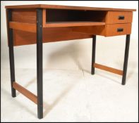 A 20th Century retro teak wood desk, raised on tubular black metal supports, two drawers to the