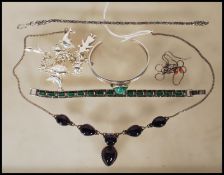 A collection of silver jewellery to include an amethyst coloured stone necklace, a green stone and