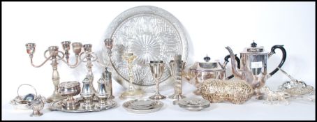 A large collection of silver plate to include salvers, candelabra, teapot, coffee pot. peanut